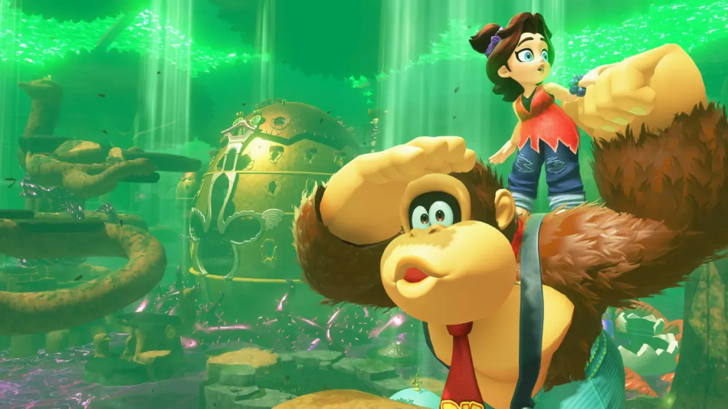 Donkey Kong ao lado de uma jovem de cabelo castanho em uma floresta de luz verde em Donkey Kong Bananza