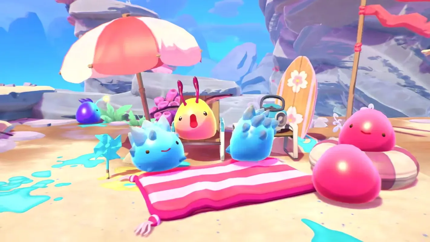 Slimes coloridos em uma praia em Slime Rancher 2